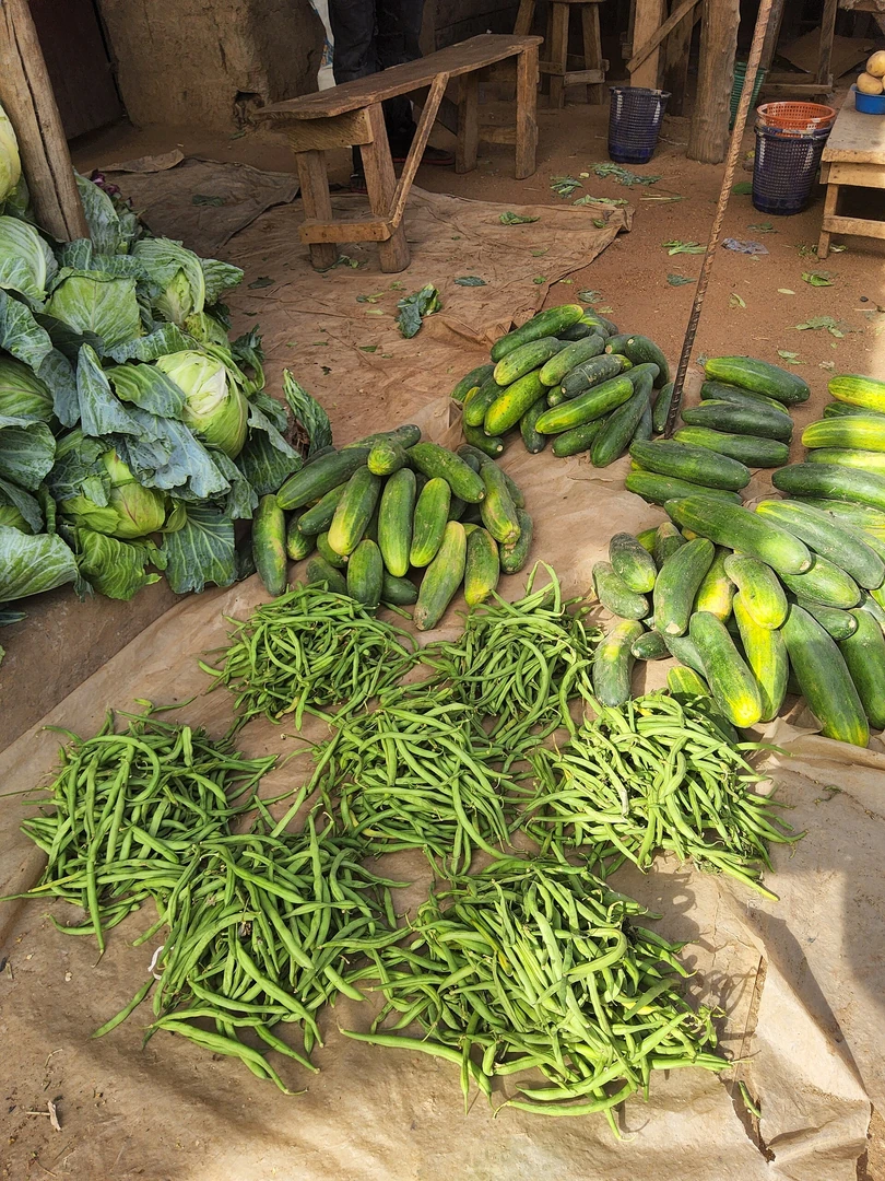 Vendor selecting fresh vegetables at a Nairobi produce market